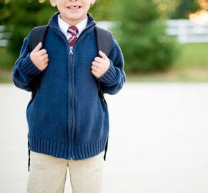 Young Boy Going to School With Backpack On